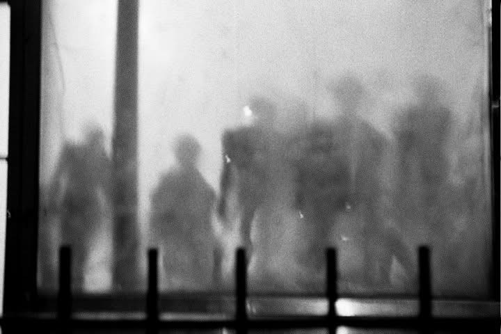 Figures softened behind a fogged city window
