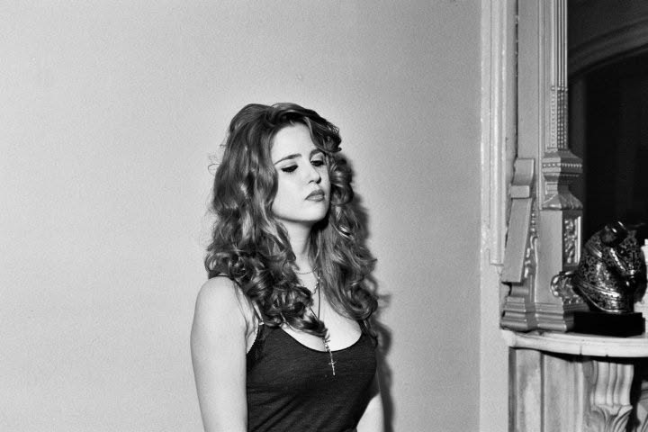A woman posing in a New York apartment during a portrait session